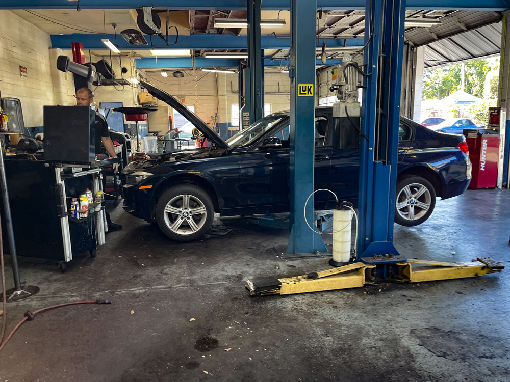 Black Car Under Repair in a Shop